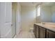 Shows a bathroom featuring double sinks, tiled floors, a glass-enclosed shower, and neutral-colored walls at 20162 W Buchanan St, Buckeye, AZ 85326
