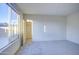 Bright carpeted bedroom with a large window and door leading to a closet at 20162 W Buchanan St, Buckeye, AZ 85326