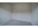 A tidy bedroom featuring neutral walls, carpet, and a closed white door at 20162 W Buchanan St, Buckeye, AZ 85326
