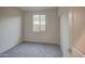 An empty bedroom featuring neutral walls, carpet, window, and a double-door closet at 20162 W Buchanan St, Buckeye, AZ 85326
