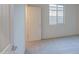 Carpeted bedroom with door, window and neutral paint at 20162 W Buchanan St, Buckeye, AZ 85326