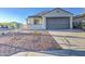 Well-maintained single-level home showcasing a spacious driveway and xeriscaped front yard at 20162 W Buchanan St, Buckeye, AZ 85326