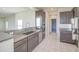 Modern kitchen boasts stainless steel appliances, granite countertops, and dark wood cabinetry, a culinary dream at 20162 W Buchanan St, Buckeye, AZ 85326