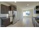 Well-equipped kitchen with stainless steel refrigerator and granite countertops at 20162 W Buchanan St, Buckeye, AZ 85326