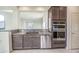 Shows a well-lit kitchen area featuring granite countertops, stainless steel appliances, and tile flooring at 20162 W Buchanan St, Buckeye, AZ 85326