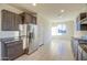 Well-lit kitchen with stainless steel appliances, granite countertops, and ample cabinet storage for convenience at 20162 W Buchanan St, Buckeye, AZ 85326