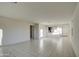 Large open-plan living room with tile floors and seamless flow to kitchen at 20162 W Buchanan St, Buckeye, AZ 85326