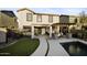 A backyard view showing the outdoor kitchen, access to the house, and pool at 21070 N Alexis Ave, Maricopa, AZ 85138