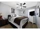 Cozy bedroom features carpet, a ceiling fan, and neutral color palette with a full bed at 21070 N Alexis Ave, Maricopa, AZ 85138