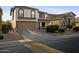 Two-story home featuring a two-car garage, neutral color palette, and landscaped front yard at 21070 N Alexis Ave, Maricopa, AZ 85138