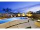 A gorgeous and refreshing pool with basketball hoop, ample seating, and outdoor lighting at 21070 N Alexis Ave, Maricopa, AZ 85138