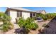 Landscaped backyard featuring a patio with a firepit and seating, with a small green shrub at 22607 W Antelope Trl, Buckeye, AZ 85326
