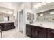 Spacious bathroom with double sinks, large mirrors, and updated fixtures offers a bright and airy feel at 22607 W Antelope Trl, Buckeye, AZ 85326