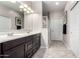 Bathroom featuring double sinks, white countertops, wood cabinets and a glass shower door at 22607 W Antelope Trl, Buckeye, AZ 85326