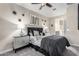 Stylish bedroom with modern decor, a ceiling fan, and soft lighting creates a comfortable retreat at 22607 W Antelope Trl, Buckeye, AZ 85326