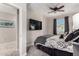 Cozy bedroom featuring a mounted TV, ceiling fan, and neutral tones for a relaxing atmosphere at 22607 W Antelope Trl, Buckeye, AZ 85326