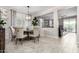 Dining area with stylish chandelier, and access to both living room and outside patio space at 22607 W Antelope Trl, Buckeye, AZ 85326