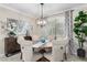 An inviting dining area with a round table, upholstered chairs, and stylish decor elements at 22607 W Antelope Trl, Buckeye, AZ 85326