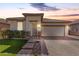 Charming single-story home with neutral stucco, tile roof, brick accents, manicured lawn, and a two-car garage at 22607 W Antelope Trl, Buckeye, AZ 85326