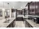 Spacious kitchen with granite countertops, stainless steel appliances, and dark wood cabinetry at 22607 W Antelope Trl, Buckeye, AZ 85326