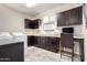 Laundry and office area boasts dark cabinets, light countertops, and updated appliances at 22607 W Antelope Trl, Buckeye, AZ 85326