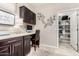 Office area offers dark cabinets, a desk, and a walk-in pantry space at 22607 W Antelope Trl, Buckeye, AZ 85326
