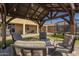 Cozy backyard patio featuring a covered seating area and well-maintained artificial turf at 26842 N 176Th Ln, Surprise, AZ 85387
