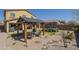 Spacious backyard with a pergola, trampoline, desert landscaping, and artificial turf at 26842 N 176Th Ln, Surprise, AZ 85387
