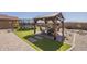 Well-maintained backyard with a pergola, artificial turf, desert landscaping, and pavers at 26842 N 176Th Ln, Surprise, AZ 85387