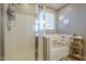 Bathroom showcases a shower with glass door, bathtub, and stylish decor at 26842 N 176Th Ln, Surprise, AZ 85387