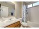 Bathroom with vanity, mirror, toilet, and a shower-tub combo with floral curtain at 26842 N 176Th Ln, Surprise, AZ 85387