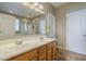 Bathroom featuring a dual sink vanity, mirror, and separate toilet and shower at 26842 N 176Th Ln, Surprise, AZ 85387
