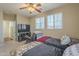 Neutral bedroom featuring two twin beds, a ceiling fan, and a TV area at 26842 N 176Th Ln, Surprise, AZ 85387