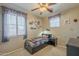 Cozy bedroom featuring a superhero theme, natural light, and a comfortable space for rest and play at 26842 N 176Th Ln, Surprise, AZ 85387