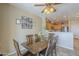 Dining area with a wood table, chairs, and an adjacent kitchen view at 26842 N 176Th Ln, Surprise, AZ 85387