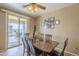 Dining room featuring a wood table, chairs and a sliding glass door to the outside at 26842 N 176Th Ln, Surprise, AZ 85387