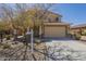 Two-story home with a two-car garage, low maintenance desert landscaping, and a tile roof at 26842 N 176Th Ln, Surprise, AZ 85387