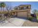 Inviting two-story home showcasing a spacious driveway and well-manicured landscaping at 26842 N 176Th Ln, Surprise, AZ 85387