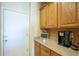 Kitchen counter with wooden cabinets, speckled countertop, and stainless steel coffee maker at 26842 N 176Th Ln, Surprise, AZ 85387