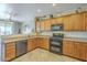Kitchen featuring oak cabinets, stainless steel appliances, and an open layout at 26842 N 176Th Ln, Surprise, AZ 85387