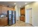 Kitchen with stainless steel refrigerator and oak cabinets at 26842 N 176Th Ln, Surprise, AZ 85387