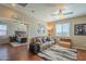 Comfortable living room with ceiling fan, views to the bedroom, and sporty decor creates a relaxing space at 26842 N 176Th Ln, Surprise, AZ 85387