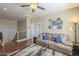 Inviting living room with comfortable seating, ceiling fan, and sporty wall decor creates a fun, relaxing atmosphere at 26842 N 176Th Ln, Surprise, AZ 85387