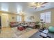 Cozy living room features tile floors, two ceiling fans, and comfortable couches at 26842 N 176Th Ln, Surprise, AZ 85387