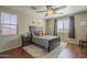 Bedroom with a decorative ceiling fan, wood flooring, and a cozy decorative rug at 26842 N 176Th Ln, Surprise, AZ 85387