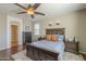Spacious main bedroom features a ceiling fan, two nightstands, and an ensuite bathroom at 26842 N 176Th Ln, Surprise, AZ 85387
