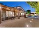 Inviting brick paver patio featuring covered dining, built-in BBQ and a lovely, illuminated pool area at 2894 E Melody Ln, Gilbert, AZ 85234