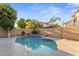Inviting backyard pool surrounded by lush landscaping and a privacy wall at 2894 E Melody Ln, Gilbert, AZ 85234