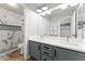 Modern bathroom with a marble shower, double vanity, gray cabinets, and decorative mirrors at 2894 E Melody Ln, Gilbert, AZ 85234