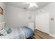 White bedroom with a ceiling fan, closet, dresser, wood-look floor, and a blue bedspread on a twin bed at 2894 E Melody Ln, Gilbert, AZ 85234